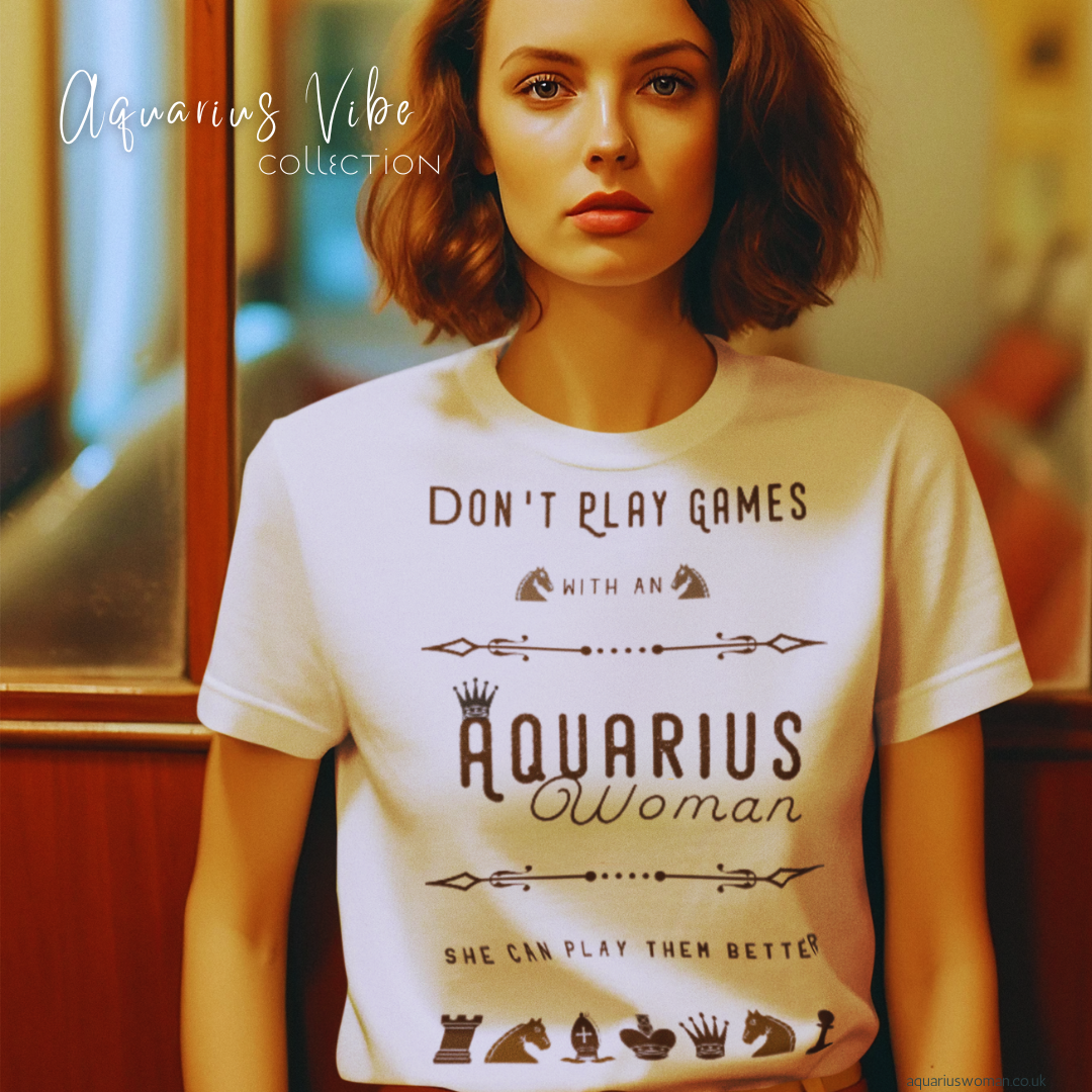 A woman wearing a âDonât Play Games with an Aquarius Womanâ t-shirt from the Aquarius Vibe Collection by Aquarius Woman. Featuring chess-inspired symbols and bold typography, this design embodies intelligence, independence, and the unapologetic nature of Aquarius energy.