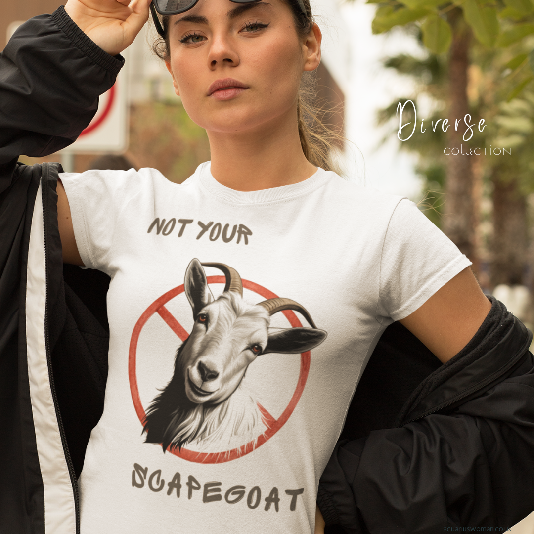 A woman wearing a âNot Your Scapegoatâ t-shirt from the Diverse Collection by Aquarius Woman. The design features a goat with a red prohibition symbol, representing breaking free from blame, standing up for justice, and embracing self-worth.
