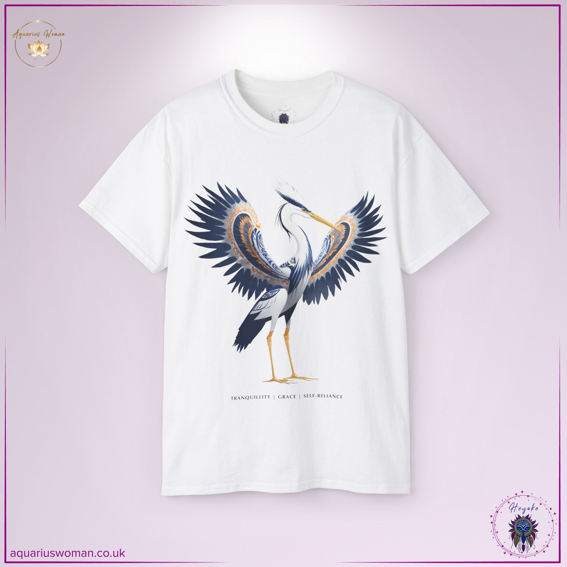 Heron Spirit Animal Tee in white from the Heyoke Collection. Features a beautifully adorned heron with wings spread wide, symbolising tranquillity, grace, and self-reliance. Deep blue and golden hues enhance the design, representing wisdom and balance.