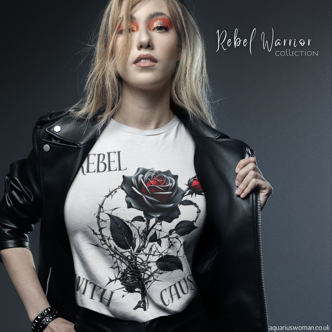 Model wearing a white 'Rebel with a Cause' t-shirt from the Rebel Warrior Collection by Aquarius Woman. Featuring a black rose entangled in barbed wire, this bold design symbolises defiance, strength, and resilience.
